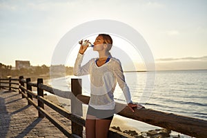 Young jogger drinking an energy drink