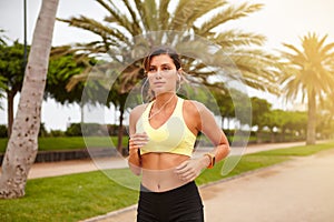 Young jogger listening to music while running