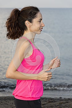 Young jogger woman jogging on beach