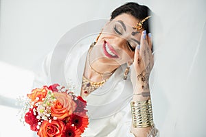 young joyful indian bride with mehndi