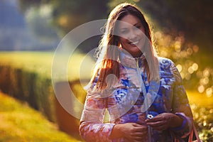 Young joyful woman in love, outdoor backlight. Emotions and happiness