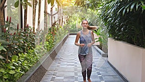 Young joyful woman running in summer day during sunrise. slow motion. Healthy way of life. 3840x2160