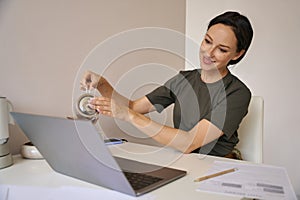 Young woman pouring herself a cup of tea