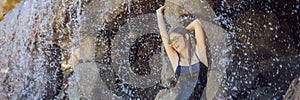 Young joyful woman under the water stream, pool, day spa, hot springs BANNER, LONG FORMAT