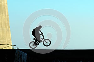 Young jumping with bicycle