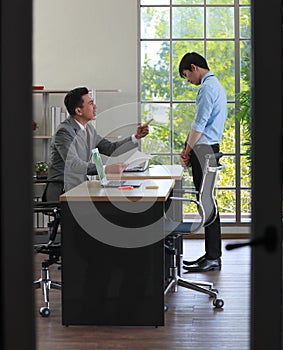 A young junior employee feels guilt and sad when the boss blame and abuses him for his wrong work. Problem and stress in daily