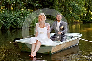 Young just married bride and groom on boat