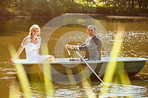 Young just married bride and groom on boat