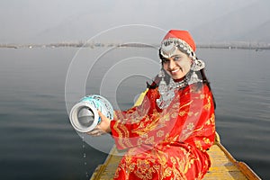 Young Kashmir Girl Collecting Water from Dal Lake photo
