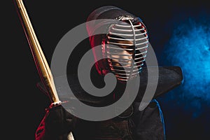 Young kendo fighter with shinai. Tradition kendo armor