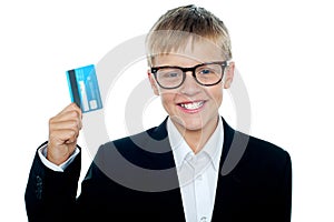 Young kid in business suit flaunting a debit card