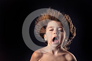 Young kid with crazy expression and flying hair