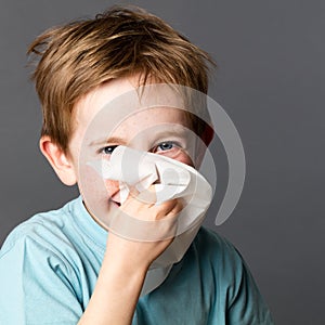 Young kid enjoying using tissue after cold or spring allergies