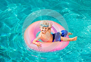 Young Kid Having Fun in the Swimming Pool