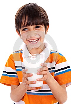 Young kid holding a glass of milk