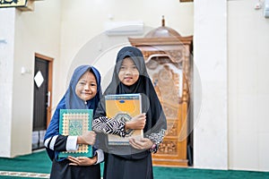 Young kid holding quran praying