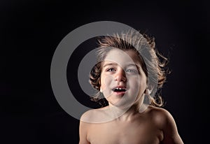 Young kid with humor expression and flying hair