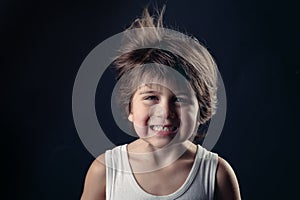 Young kid with humor expression and flying hair