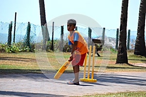 Young Kid Playing Cricket at Street