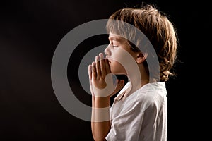 A young kid in a spiritual peaceful moment praying