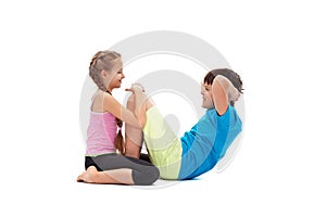 Young kids doing abs exercises together - helping each other