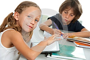 Young kids doing schoolwork together at desk. photo