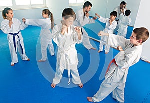 Young kids sparring in pairs in karate class