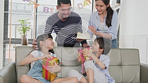 Young kids are surprised by a birthday party and celebrate with family together.