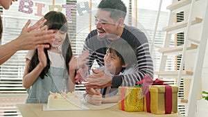 Young kids are surprised by a birthday party and celebrate with family together.