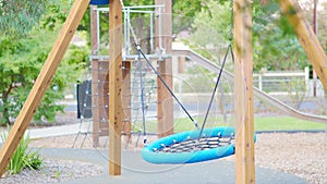 Young kids swing waving in the child playground