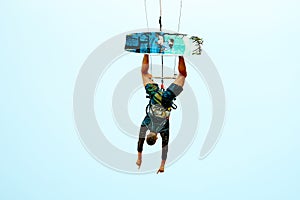 Young kitesurfer jumping in the sky on the board