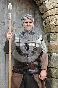 Young knight on guard at castle`s gate