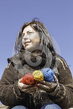 Young knitter with coloured yarn of wool