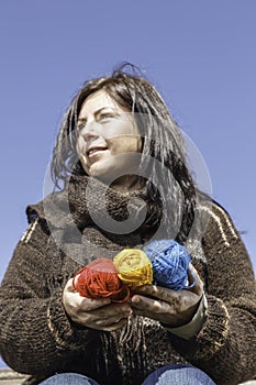 Young knitter with coloured yarn of wool photo