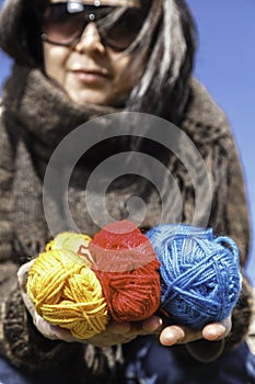 Young knitter with coloured yarns of wool