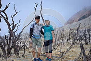 A young korean couple are doing outdoor activities on mountain. Papandayan Mountain is one of the favorite place to hike on Garut