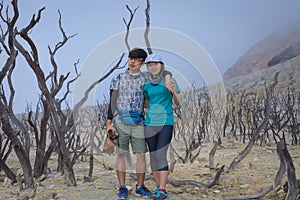 A young korean couple are doing outdoor activities on mountain. Papandayan Mountain is one of the favorite place to hike on Garut