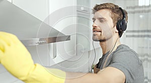 Young Lad With Beard Wiping Kitchen Hood