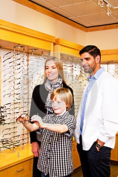 Young lad checking out options for glasses