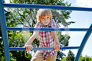 Young lad climbing on playground photo