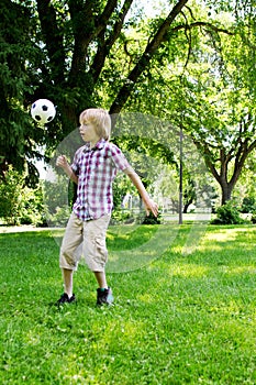 Young lad kicking soccer ball photo