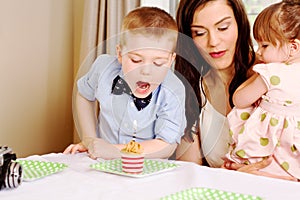 Young lad poised to blow out candle