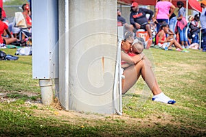Young Lady Attends Baby Between Track Heats