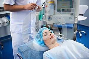 Young lady being under narcosis during the surgery in hospital