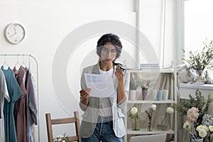 Young lady designer searching information in internet using virtual assistant photo