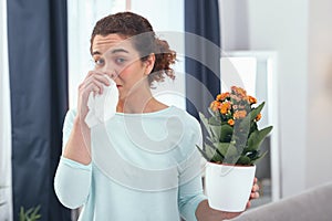 Young lady discovering being allergic to blooming plants