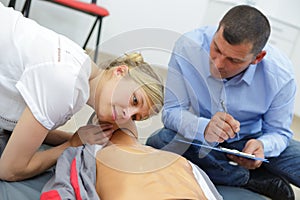 Young lady doing cpr training with dummy