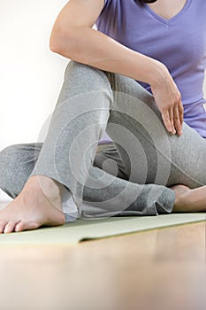 Young lady doing Spine twisting pose