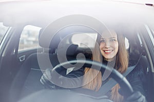 Young lady driving a car in winter