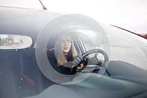 Young lady driving a car in winter